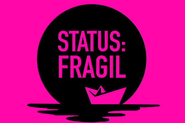 Papierboot auf pinkfarbenem Hintergrund mit der Aufschrift "Status: Fragil"